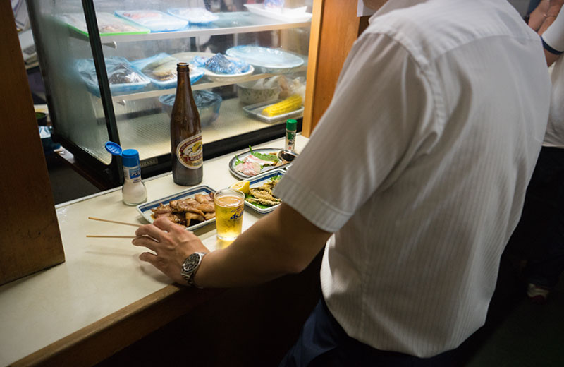 Office workers taking Kirin’s lager beer in standing-and-drink bar