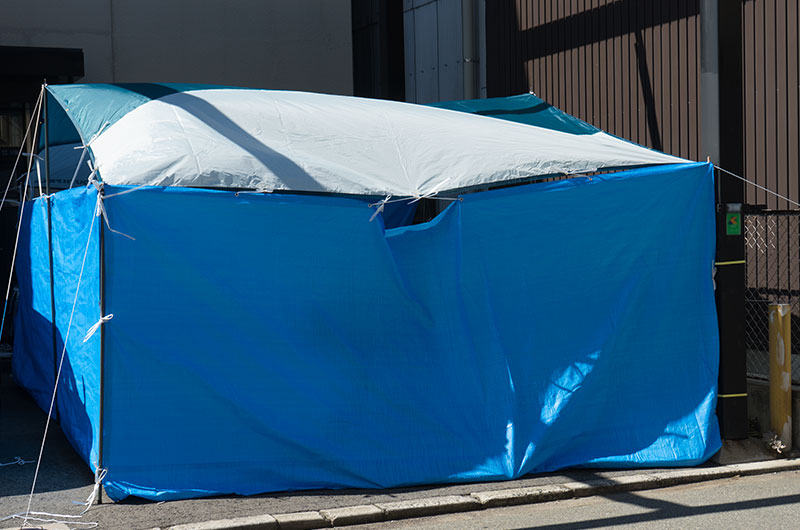 SOUTHFIELD rectangular camp tarp tent and Indoor pool surrounded by blue sheets.