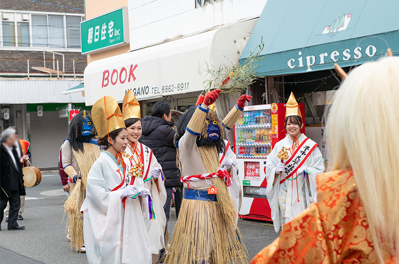 Shrine Maidens and demons patrolling in front of Hattori-tenjin station of Hankyu line at Setsubun festival of Hattori Shrine in second year of Reiwa